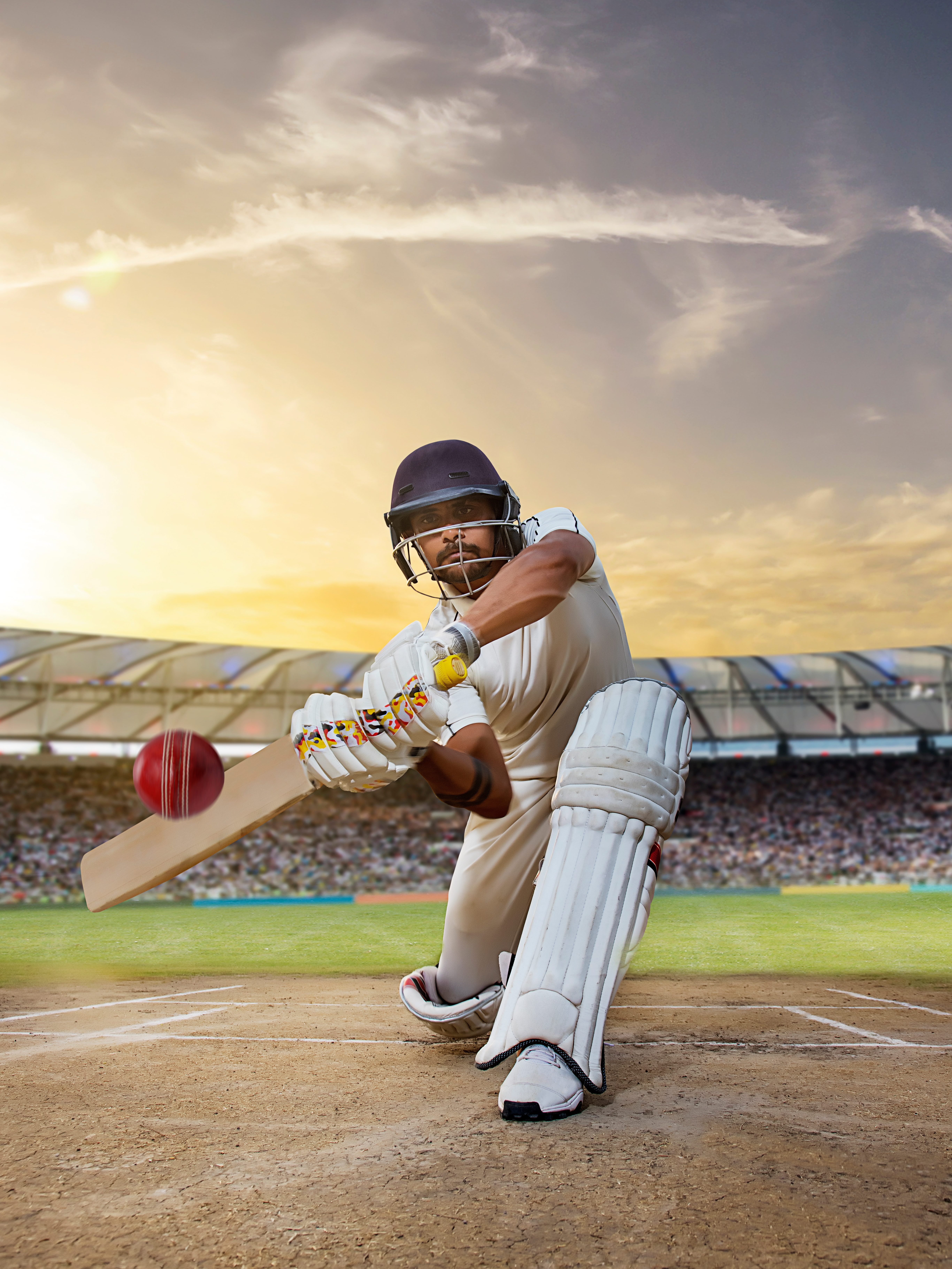 Cricketer batsman hitting a shot during a match on the pitch